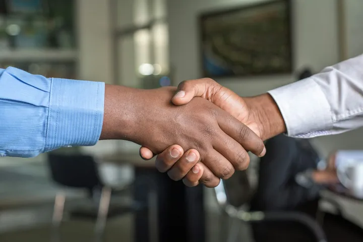 Aperto de mão entre duas pessoas